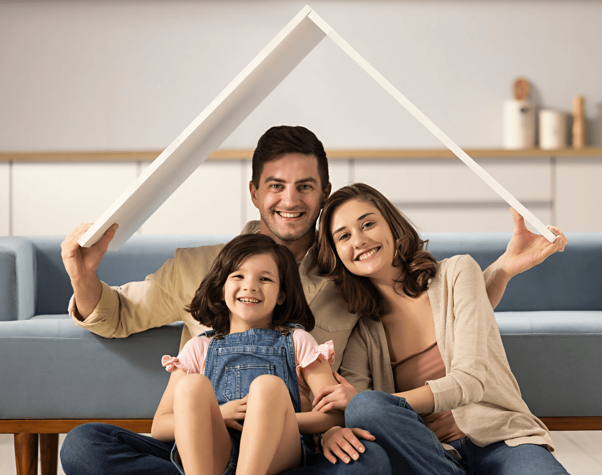 Happy family under miniature roof